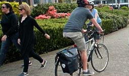 People walking and cycling along seawall along False Creek