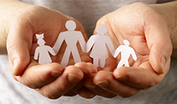 Hands holding paper dolls